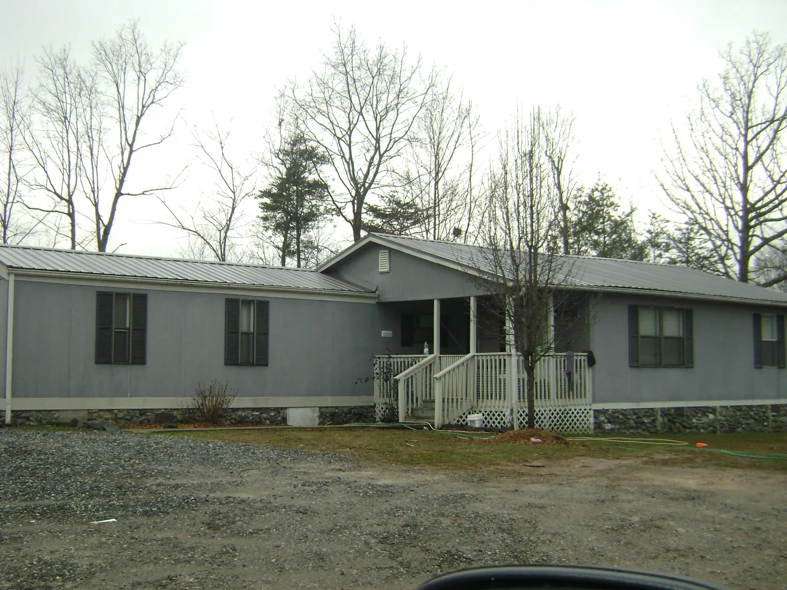 Metal roof over a manufactured home with a covered front porch in Skillman